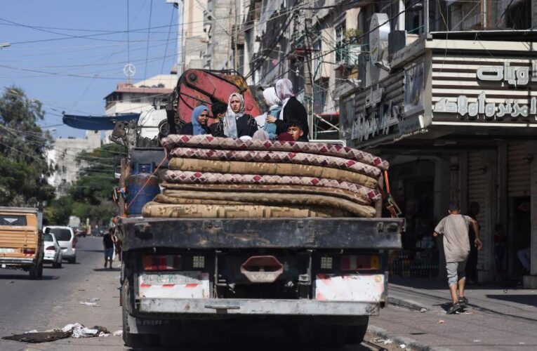 Tens of thousands flee south in Gaza as Israeli troops gather near border